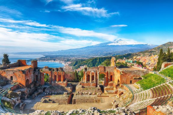 Ancient Greek Amphi theater and mt Etna in Taormina, Sicily, Italy