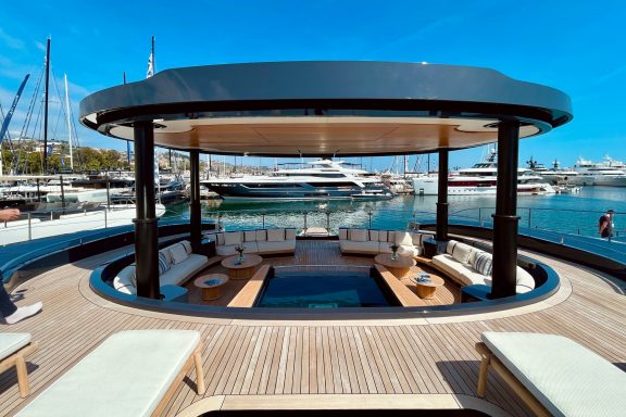 Luxury power catamaran SEAWOLF X foredeck with lounge with hydraulic roof